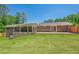 Expansive backyard featuring a brick patio, lush lawn, and a covered porch, perfect for outdoor entertaining at 2133 Bird Ln, Snellville, GA 30078