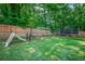 Spacious backyard with playset, trampoline, and fenced perimeter at 2133 Bird Ln, Snellville, GA 30078