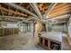 Spacious unfinished basement with concrete floors and exposed ductwork at 2133 Bird Ln, Snellville, GA 30078