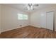 Well-lit bedroom includes a ceiling fan, closet, and a window offering ample natural light at 2133 Bird Ln, Snellville, GA 30078