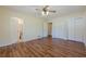 Bright bedroom featuring laminated wood flooring, two closets, and a ceiling fan at 2133 Bird Ln, Snellville, GA 30078