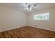 Light-filled bedroom features wood look floors, a ceiling fan, and a window at 2133 Bird Ln, Snellville, GA 30078