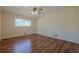 Bedroom featuring laminated wood flooring, a window and ceiling fan at 2133 Bird Ln, Snellville, GA 30078