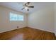 Bright bedroom features hardwood floors, a ceiling fan, and a window at 2133 Bird Ln, Snellville, GA 30078