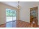 Bright dining room featuring wood floors, classic chandelier, and sliding glass doors to the backyard patio at 2133 Bird Ln, Snellville, GA 30078