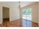 Dining room with wood floors, neutral walls, and sliding glass doors leading to an outdoor patio at 2133 Bird Ln, Snellville, GA 30078