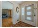 Inviting entryway featuring a light-filled doorway and wood floors, leading to a cozy living area with a fireplace at 2133 Bird Ln, Snellville, GA 30078