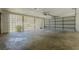 Spacious garage with concrete floor, decorative block wall, and garage door at 2133 Bird Ln, Snellville, GA 30078
