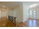 Bright hallway with wood floors and railing leading to the front door at 2133 Bird Ln, Snellville, GA 30078