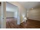 Hallway featuring wood floors, neutral paint, and white doors, creating a bright and open feel throughout the home at 2133 Bird Ln, Snellville, GA 30078