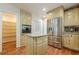 Well-lit kitchen featuring stainless steel appliances, custom cabinets, granite countertops, and convenient pantry at 2133 Bird Ln, Snellville, GA 30078
