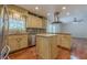 Kitchen with stainless steel appliances, a center island, a tile backsplash, and ample storage at 2133 Bird Ln, Snellville, GA 30078