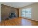 Living room with a striking brick fireplace and ample natural light from a large window, enhancing the inviting space at 2133 Bird Ln, Snellville, GA 30078
