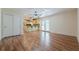 Open-concept living room with wood floors, neutral walls, and direct access to kitchen and backyard at 2133 Bird Ln, Snellville, GA 30078