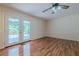 Living room featuring a ceiling fan, neutral walls, wood floors, and glass doors leading to the backyard at 2133 Bird Ln, Snellville, GA 30078