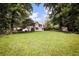 Spacious backyard with mature trees and a shed, providing ample space for outdoor activities and storage at 239 Clear Brook Trl, Douglasville, GA 30134