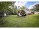 Large backyard with mature trees and a shed, offering plenty of space for recreation and storage at 239 Clear Brook Trl, Douglasville, GA 30134