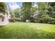 Expansive backyard featuring lush green lawn and mature trees, perfect for outdoor enjoyment at 239 Clear Brook Trl, Douglasville, GA 30134