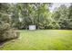 Lush backyard featuring mature trees and a shed providing serene outdoor space and storage at 239 Clear Brook Trl, Douglasville, GA 30134