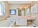 Bright bathroom featuring a tub, cabinets, and ample vanity space, offering a serene and functional design at 239 Clear Brook Trl, Douglasville, GA 30134