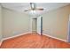 Spacious bedroom with hardwood floors, neutral walls, a ceiling fan, and access to another room at 239 Clear Brook Trl, Douglasville, GA 30134