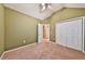 Neutral bedroom with a vaulted ceiling, fan, window, closet, and carpeted floor at 239 Clear Brook Trl, Douglasville, GA 30134