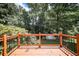 Wooden deck with black metal railing and wooded views at 239 Clear Brook Trl, Douglasville, GA 30134