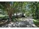 Single-story home with attached garage, a long driveway, and mature trees providing shade at 239 Clear Brook Trl, Douglasville, GA 30134