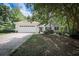 Inviting single-story home with a large garage and a well-maintained front lawn and established trees at 239 Clear Brook Trl, Douglasville, GA 30134