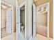Hallway featuring three doorways, one to the closet, one to the bathroom, and one to the bedroom at 239 Clear Brook Trl, Douglasville, GA 30134