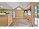 Bright kitchen and breakfast nook featuring tile floors, white appliances, and a door to the outside at 239 Clear Brook Trl, Douglasville, GA 30134