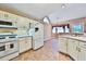 Well-lit kitchen area features white appliances and an adjacent breakfast nook at 239 Clear Brook Trl, Douglasville, GA 30134