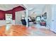 Spacious living room showcasing hardwood floors, fireplace, and an open layout into the kitchen at 239 Clear Brook Trl, Douglasville, GA 30134