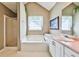 Bright bathroom featuring a soaking tub, a shower, and a single sink vanity at 239 Clear Brook Trl, Douglasville, GA 30134