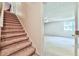 Carpeted staircase leads to an upstairs room featuring carpeted floors and paneled ceilings at 239 Clear Brook Trl, Douglasville, GA 30134