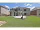Large grassy backyard with screened-in porch and basketball hoop for outdoor enjoyment at 4100 Secret Shoals Way, Buford, GA 30518