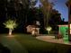 Large, well-lit backyard with basketball hoop, patio, and ambient outdoor lighting at 4100 Secret Shoals Way, Buford, GA 30518