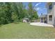 Manicured backyard with a basketball hoop and shed at 4100 Secret Shoals Way, Buford, GA 30518