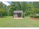 Backyard shed sitting on a lush green lawn at 4100 Secret Shoals Way, Buford, GA 30518