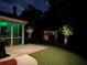 Beautiful backyard at night with an outdoor fireplace and ambient outdoor lighting at 4100 Secret Shoals Way, Buford, GA 30518