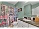 Stylish bathroom with elegant granite countertop, a decorative shower curtain, and modern fixtures at 4100 Secret Shoals Way, Buford, GA 30518