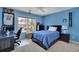 Bright bedroom with carpeted floors, blue walls, a ceiling fan, and a double bed under the window at 4100 Secret Shoals Way, Buford, GA 30518
