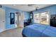 Bedroom features light blue walls, carpeted floors, a ceiling fan, and a double bed at 4100 Secret Shoals Way, Buford, GA 30518