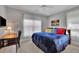 Cozy bedroom featuring a ceiling fan, wall-mounted TV, and a study corner providing functionality at 4100 Secret Shoals Way, Buford, GA 30518