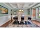 Dining room featuring elegant wainscoting, a coffered ceiling, and a large window at 4100 Secret Shoals Way, Buford, GA 30518