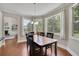 Bright dining room with hardwood floors, large windows, and a modern chandelier, perfect for Gathering meals at 4100 Secret Shoals Way, Buford, GA 30518