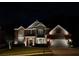 Stunning exterior home view showcasing brick, stone, and professional landscaping and lighting at 4100 Secret Shoals Way, Buford, GA 30518