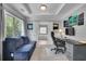 Comfortable home office with modern decor, a desk, and a sofa, offering a versatile workspace at 4100 Secret Shoals Way, Buford, GA 30518
