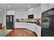 The kitchen has white cabinets, modern appliances, and a tile backsplash at 4100 Secret Shoals Way, Buford, GA 30518