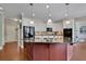 Well-equipped kitchen with stainless steel appliances, granite countertops, and custom white cabinets at 4100 Secret Shoals Way, Buford, GA 30518